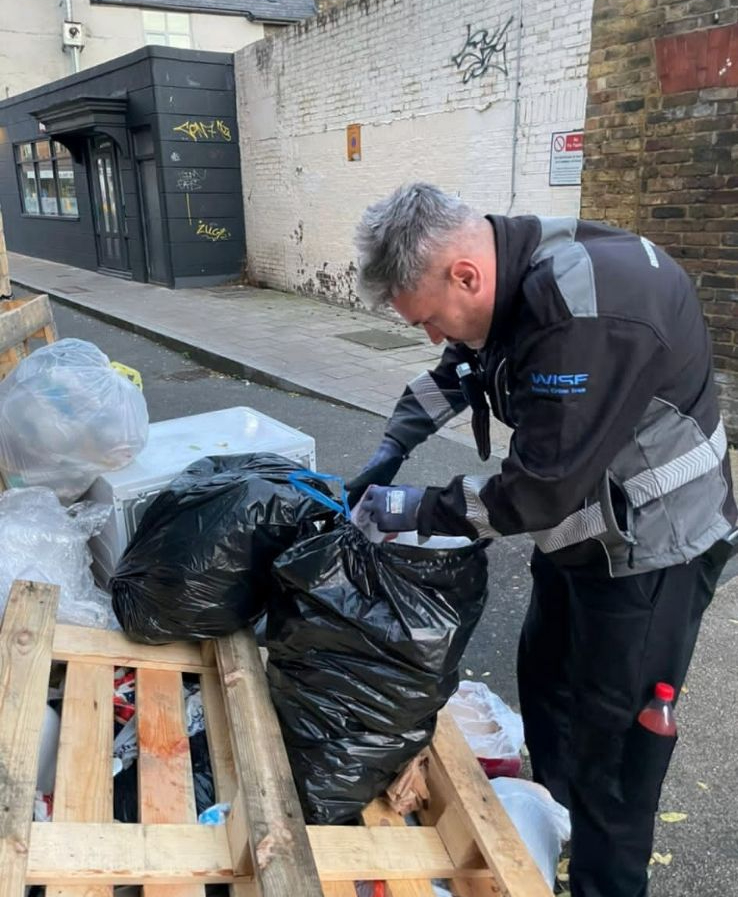 WISE officer examining waste