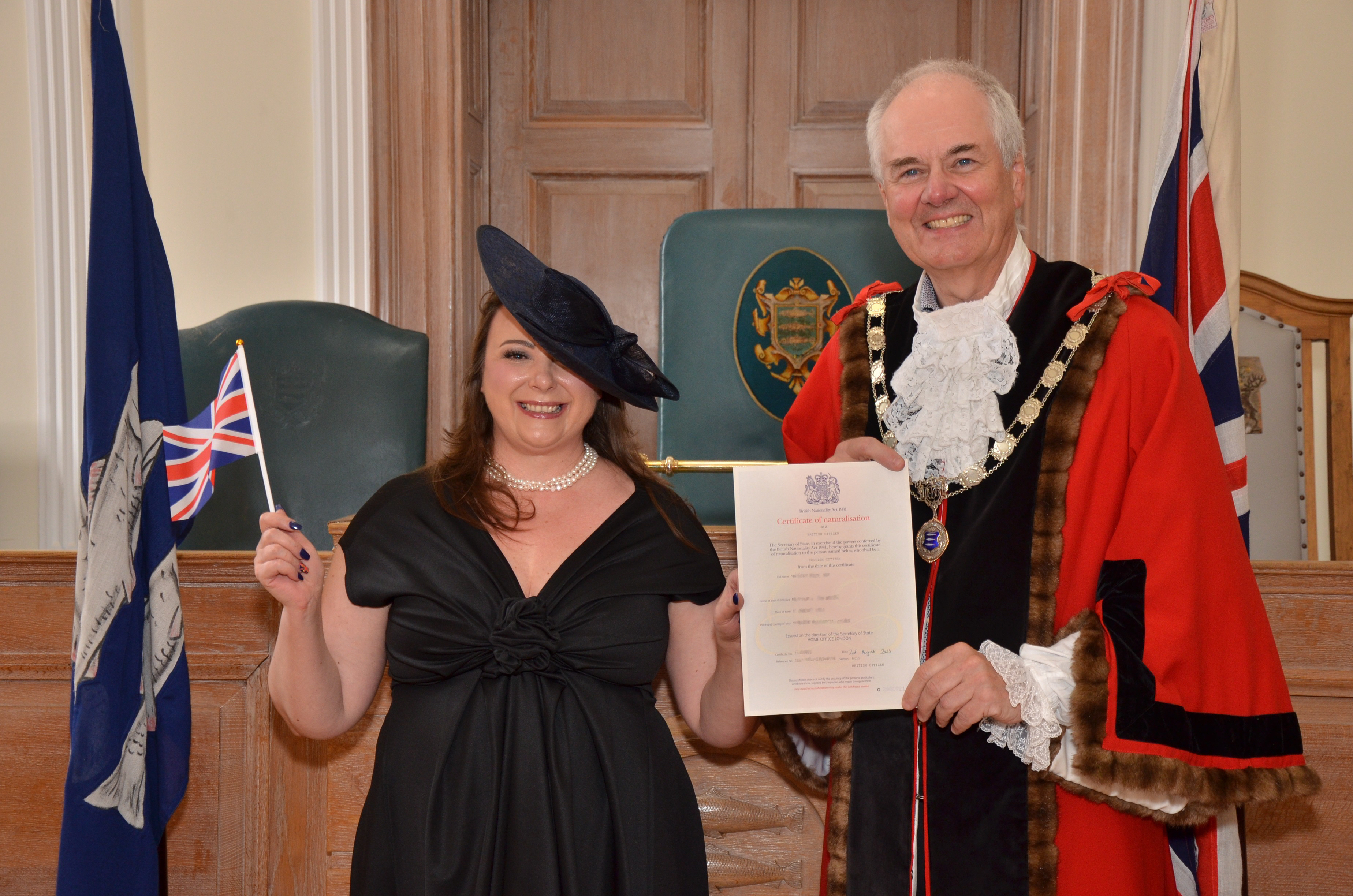 Mayor presents citizenship certificate to a resident